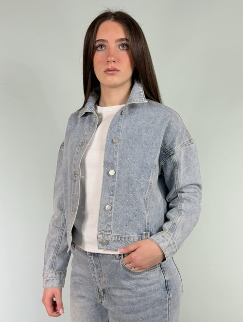 Giubbetto jeans chiaro con dettagli di strass sul davanti.