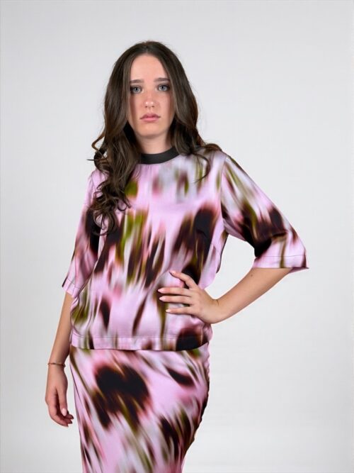 Blusa a fantasia, maniche al gomito. Girocollo con rifinitura a contrasto di colore.