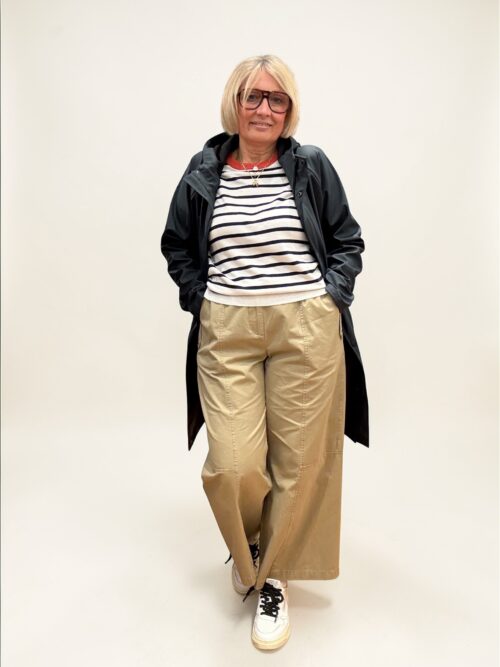 Pantalone color biscotto, gamba dritta con elastico in vita e allacciatura con due bottoni e zip.